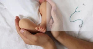 Hands cradling a baby's feet